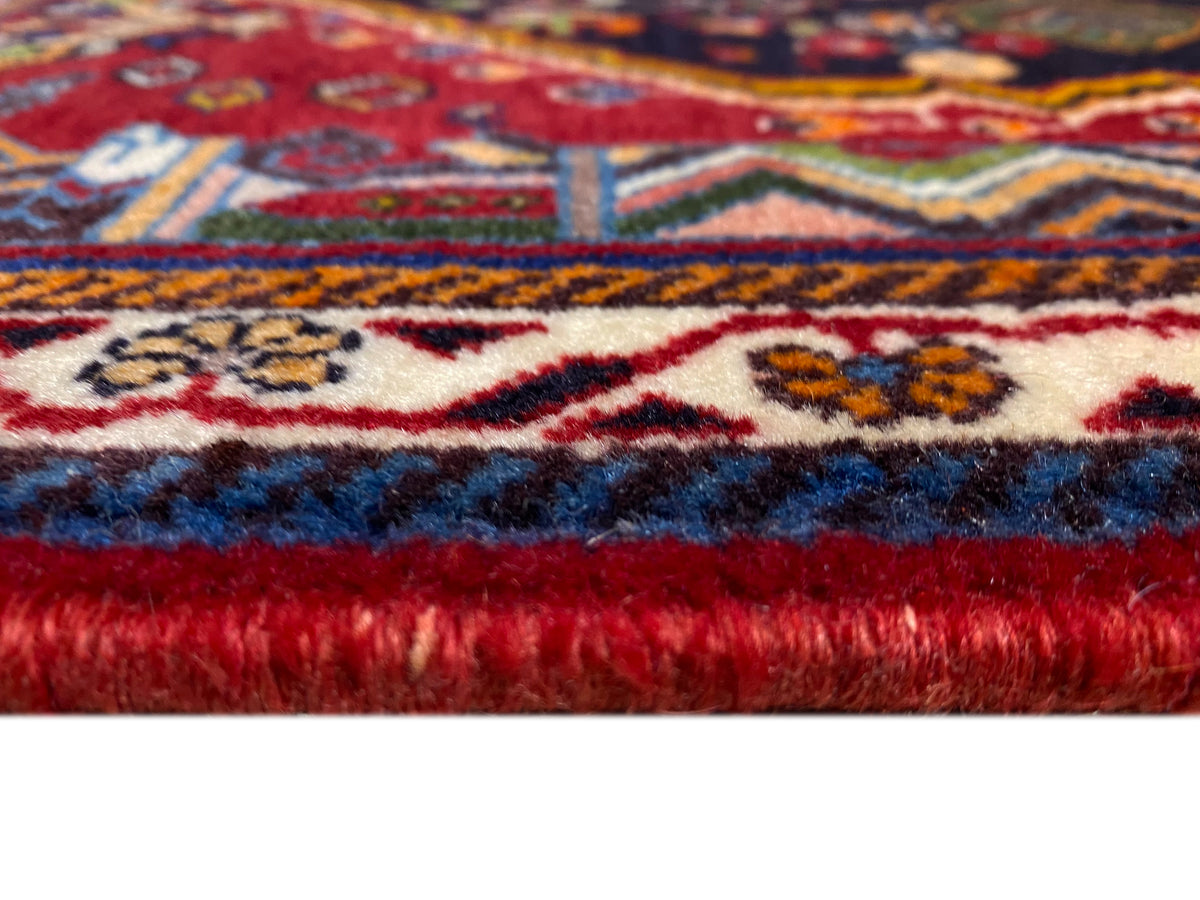 Poshti-tapijt: franjesnaad en zelfkant met kleurverloop van blauw naar rood