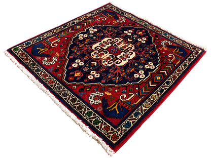 Vierkant vloerkleed met kleurrijk ornament, diepblauw oppervlak, randmotieven, franjes